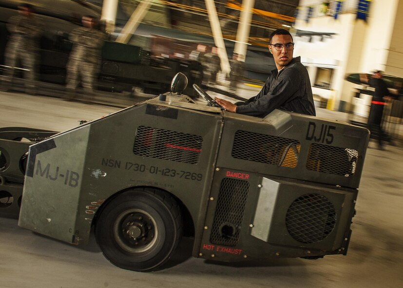 Senior Airman Matise Venett, 5th Aircraft Maintenance Squadron weapons load crew member, reverses a jammer during the Global Strike Challenge bomb-loading competition at Minot Air Force Base, N.D., June 19, 2017. Sanchez was responsible for transporting the training munitions from the storage racks to the aircraft, where they were loaded into the bomb bay. (U.S. Air Force photo/Senior Airman J.T. Armstrong)