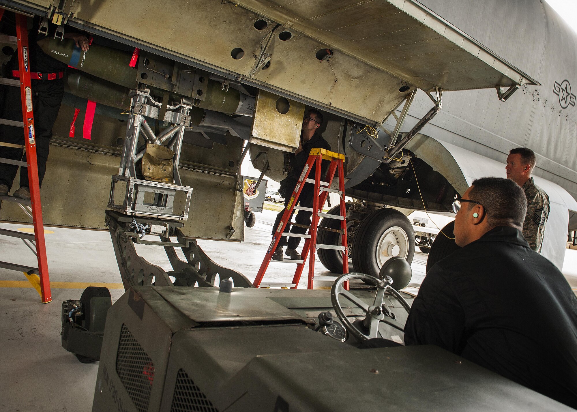 Members of the 5th Aircraft Maintenance Global Strike Challenge team load an inert GBU-38 munition into a B-52H Stratofortress at Minot Air Force Base, N.D., June 19, 2017. During the competition, the four-member team was evaluated and scored based on their speed, precision and bomb-loading expertise. (U.S. Air Force photo/Senior Airman J.T. Armstrong)