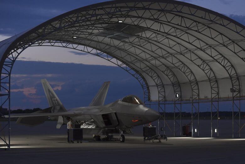 U.S. Air Force Airmen assigned to the 94th Aircraft Maintenance Unit perform maintenance on an F-22 Raptor at Joint Base Langley-Eustis, Va., June 26, 2017. In April, 2017 18 new canvas-toped sun shelters were built for the 1st Fighter Wing to provide shelter for Airmen on the flightline who working on the aircraft. (U.S. Air Force photo/Airman 1st Class Tristan Biese)