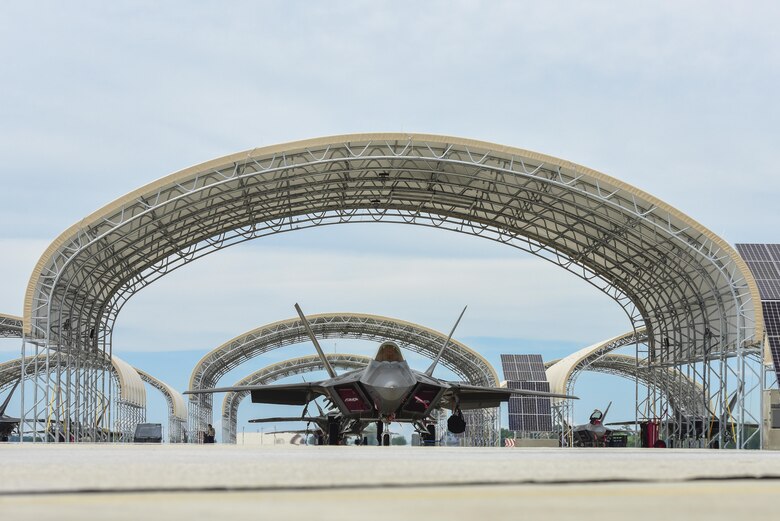 An U.S. Air Force F-22 Raptor sits under a sun shelter at Joint Base Langley-Eustis, Va., June 19, 2017. The newly built sun shelters protect the fifth-generation aircraft from corrosion and damage that may be cause by the weather. (U.S. Air Force photo/Airman 1st Class Tristan Biese)