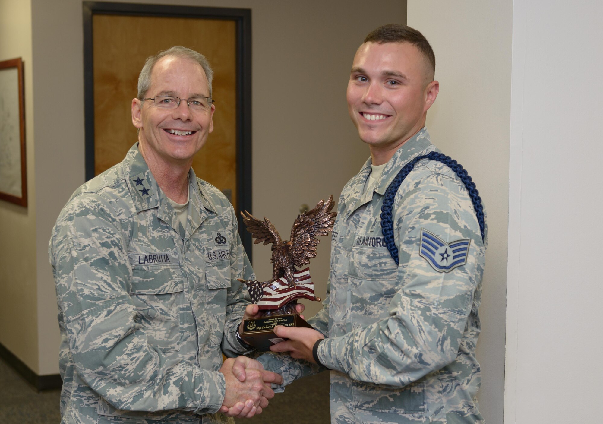 Maj. Gen. Bob LaBrutta, 2nd Air Force commander, presents the 2nd AF Outstanding NCO of the Year award to Staff Sgt. Zachary Bartlett, 81st Training Support Squadron military training leader, in the Levitow Training Support Facility June 20, 2017, on Keesler Air Force Base, Miss. Military training leaders are responsible for scheduling and conducting military training functions for Non-prior Service Airmen attending technical school. They also provide advice and to counsel to the Airmen. (U.S. Air Force photo by André Askew)
