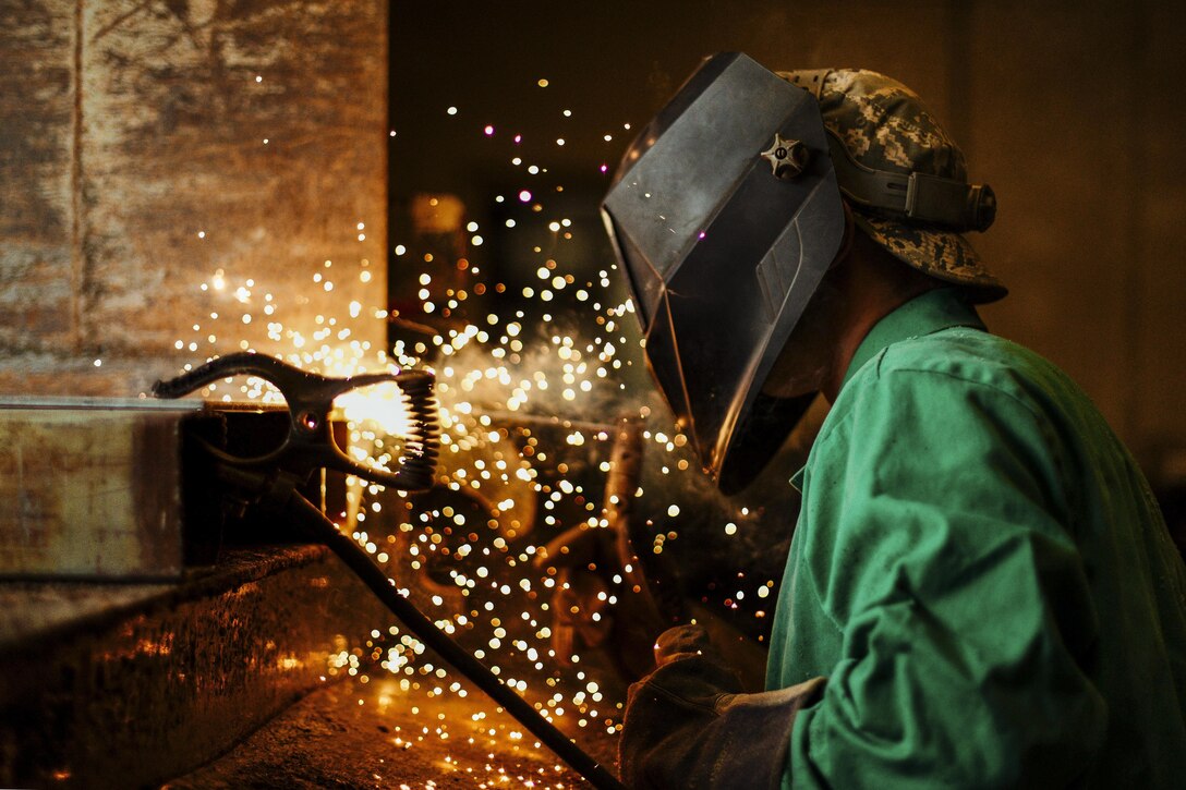 Air Force Airman 1st Class Hogan Lambeth welds a metal casing on a salt truck at Joint Base Andrews, Md., June 21, 2017. The casing ensures that winter weather will not impede missions. Air Force photo by Senior Airman Delano Scott