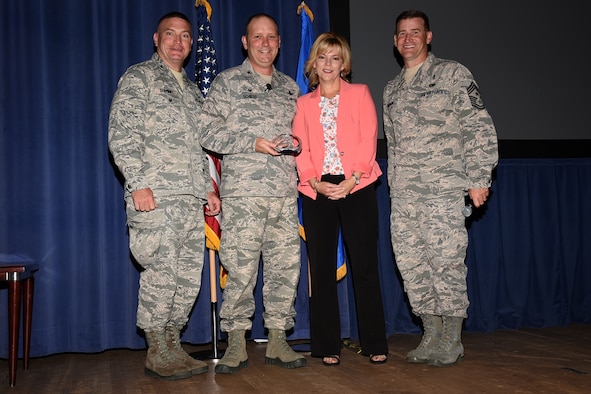 PETERSON AIR FORCE BASE, Colo. – Col. Doug Schiess, 21st Space Wing commander, and his wife, Debbie, are presented the 2017 General and Mrs. Jerome F. O’Malley Award during a 21st SW commanders call at the base auditorium, Peterson Air Force Base, Colo., June 21, 2017. The award acknowledges their leadership and contributions to Air Force families and the communities during Schiess’s time leading the 21st SW. (U.S. Air Force photo by Robb Lingley)
