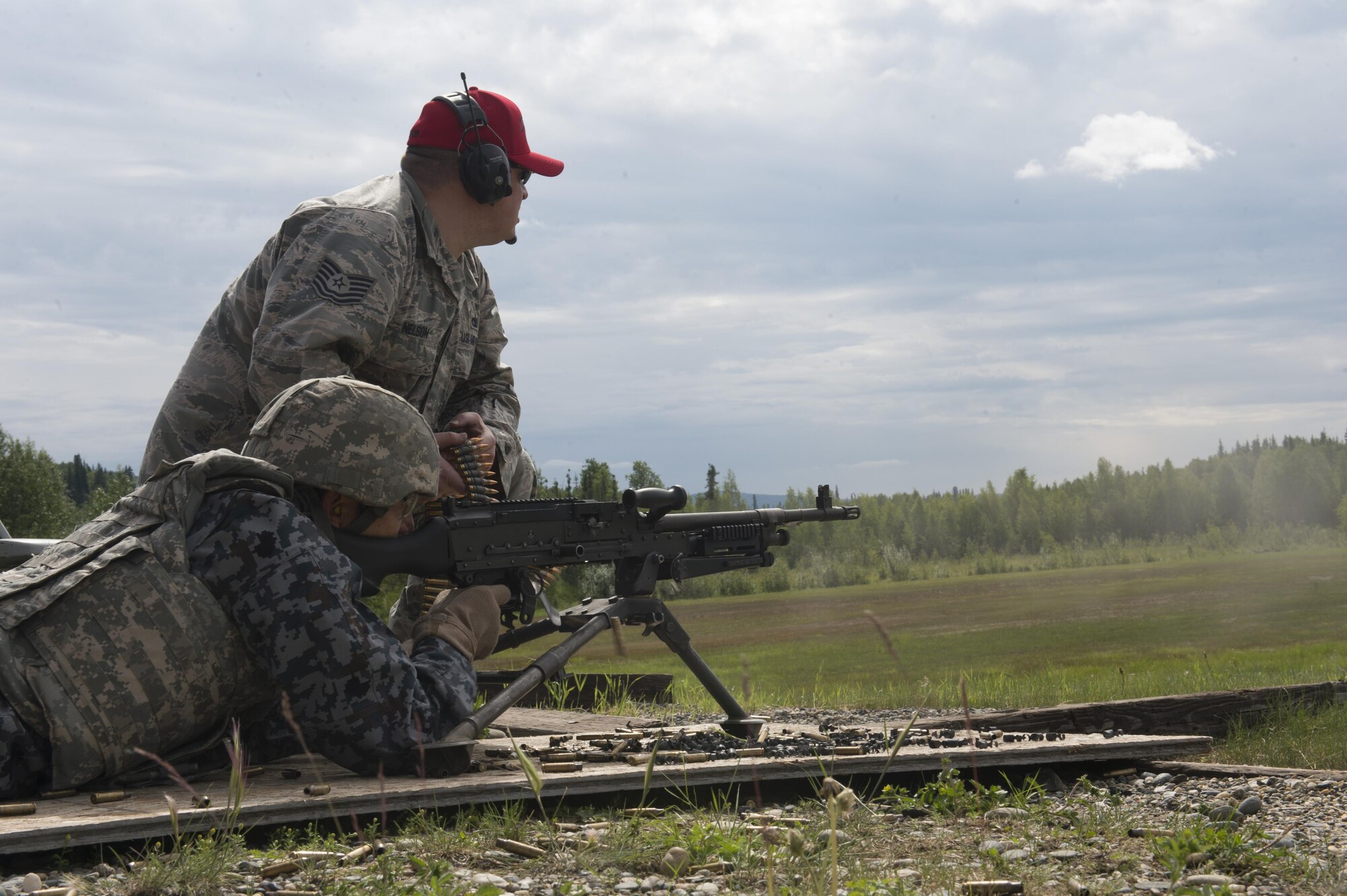 Warrant Office Katsumi Yamakazi, the Japan Air Self Defense Force (JASDF) senior enlisted advisor, fires an M240 machine gun with guidance from U.S. Air Force Tech. Sgt. Tommy Nelson, the 354th Security Forces Squadron non-commissioned officer in charge of combat arms, June 23, 2017, at Eielson Air Force Base, Alaska. Yamazaki will soon retire after serving in the JASDF for more than 34 years. (U.S. Air Force photo by Airman 1st Class Isaac Johnson)