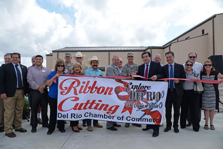 Members of Laughlin Air Force Base, the city of Del Rio, Val Verde County, and the state of Texas join together to cut the ribbon for the Defense Control Center at Laughlin AFB, Texas June 26, 2017.  The Defense Control Center, located outside the West Gate, will allow the base’s security forces the ability to inspect vehicles with state-of-the-art technology, while ensuring the safety of the base’s community.  