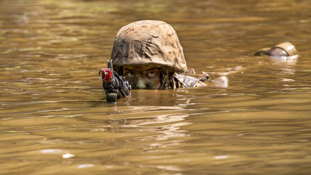 A Marine navigates a water obstacle at the Officer Candidate School at Marine Corps Base Quantico, Va., June 14, 2017. Candidates train for three months to evaluate leadership, moral, mental and physical qualities required for commissioning as a Marine Corps officer. Marine Corps photo by Lance Cpl. Cristian L. Ricardo