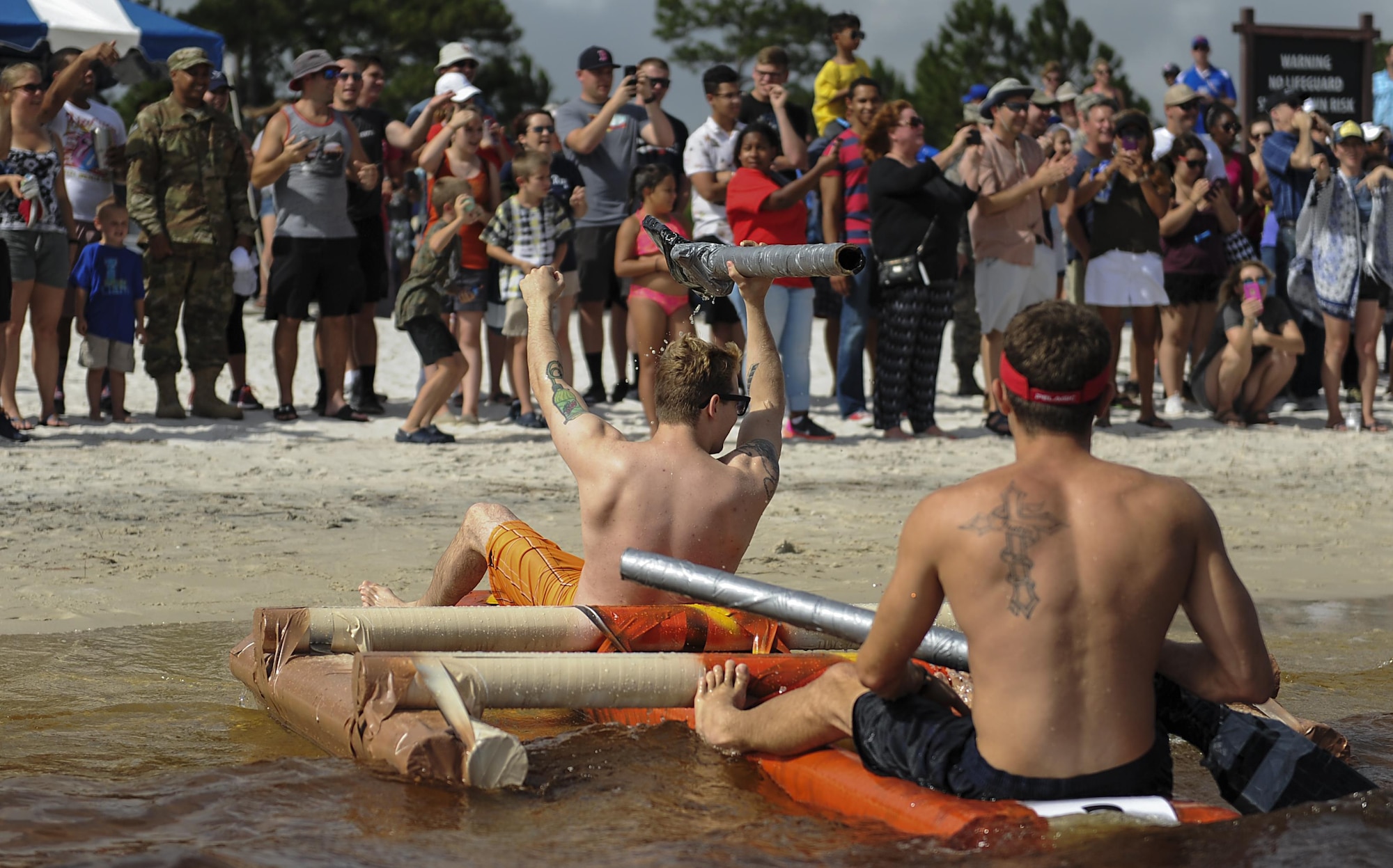 Members of the 1st Special Operations Contracting Squadron celebrate finishing the annual cardboard boat regatta at Hurlburt Field, Fla., June 23, 2017. The 1st SOCONS team took second place out of the six teams who competed. (U.S. Air Force photo by Airman 1st Class Rachel Yates)