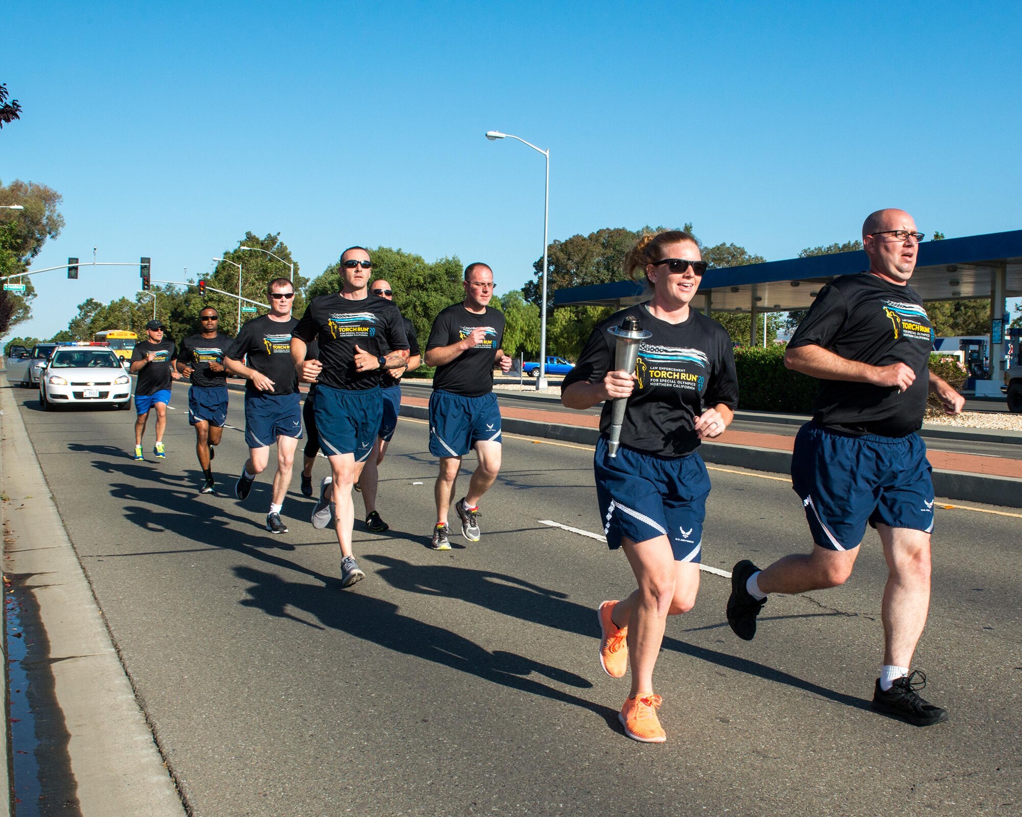 Members of the 60th Security Forces Squadron run with “The Flame of Hope” Special Olympics Torch at Travis Air Force Base, Calif., June 22, 2017. The defenders are running the torch to the California Department of Corrections prison facility in Vacaville, Calif. The event brings local law enforcement together from Solano County to show their support for the Special Olympics. (U.S. Air Force photo by Louis Briscese)