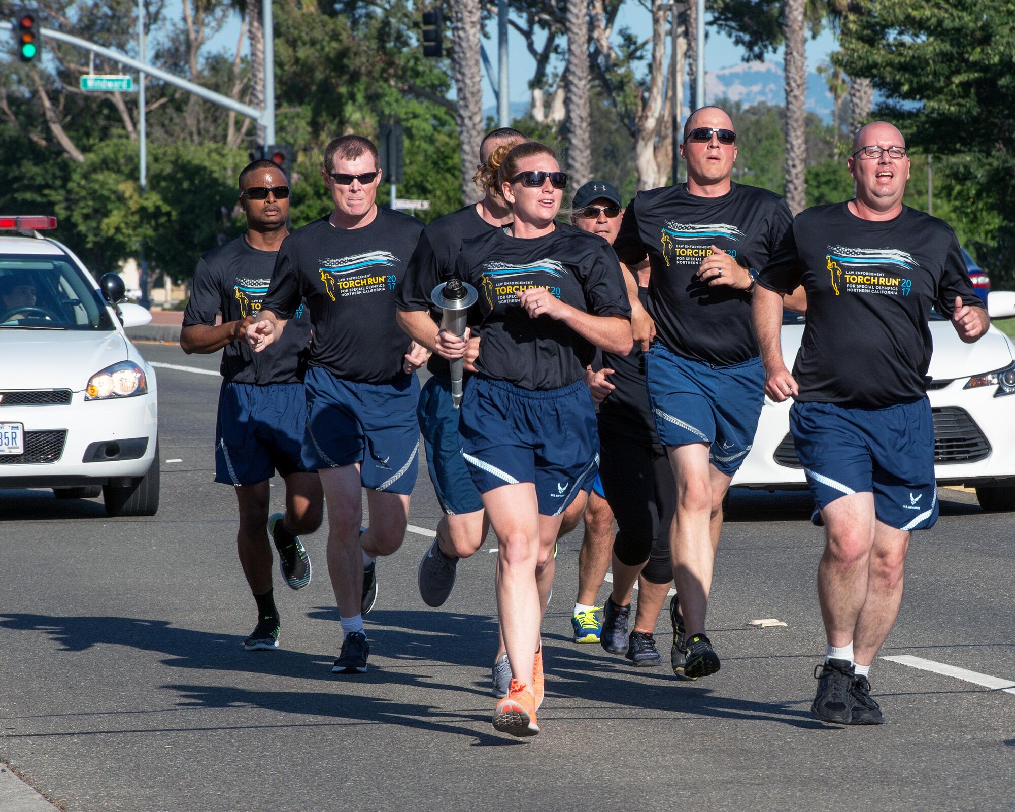 Members of the 60th Security Forces Squadron run with “The Flame of Hope” Special Olympics Torch at Travis Air Force Base, Calif., June 22, 2017. The defenders are running the torch to the California Department of Corrections prison facility in Vacaville, Calif. The event brings local law enforcement together from Solano County to show their support for the Special Olympics. (U.S. Air Force photo by Louis Briscese)