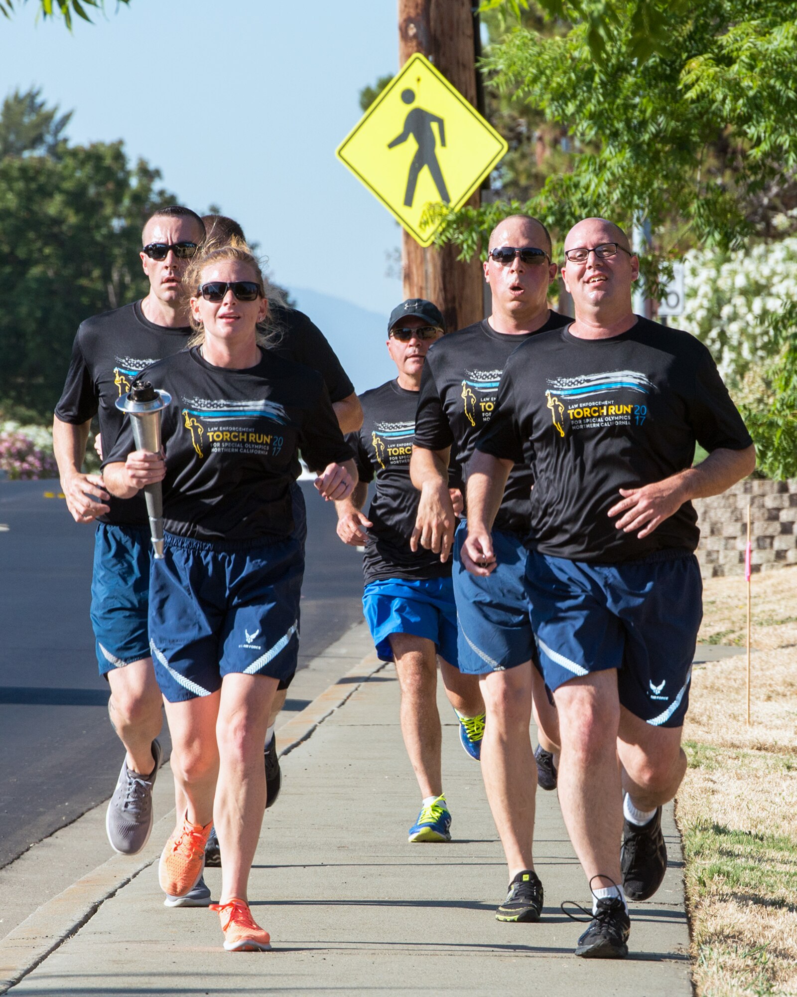 Members of the 60th Security Forces Squadron run with “The Flame of Hope” Special Olympics Torch at Travis Air Force Base, Calif., June 22, 2017. The defenders are running the torch to the California Department of Corrections prison facility in Vacaville, Calif. The event brings local law enforcement together from Solano County to show their support for the Special Olympics. (U.S. Air Force photo by Louis Briscese)