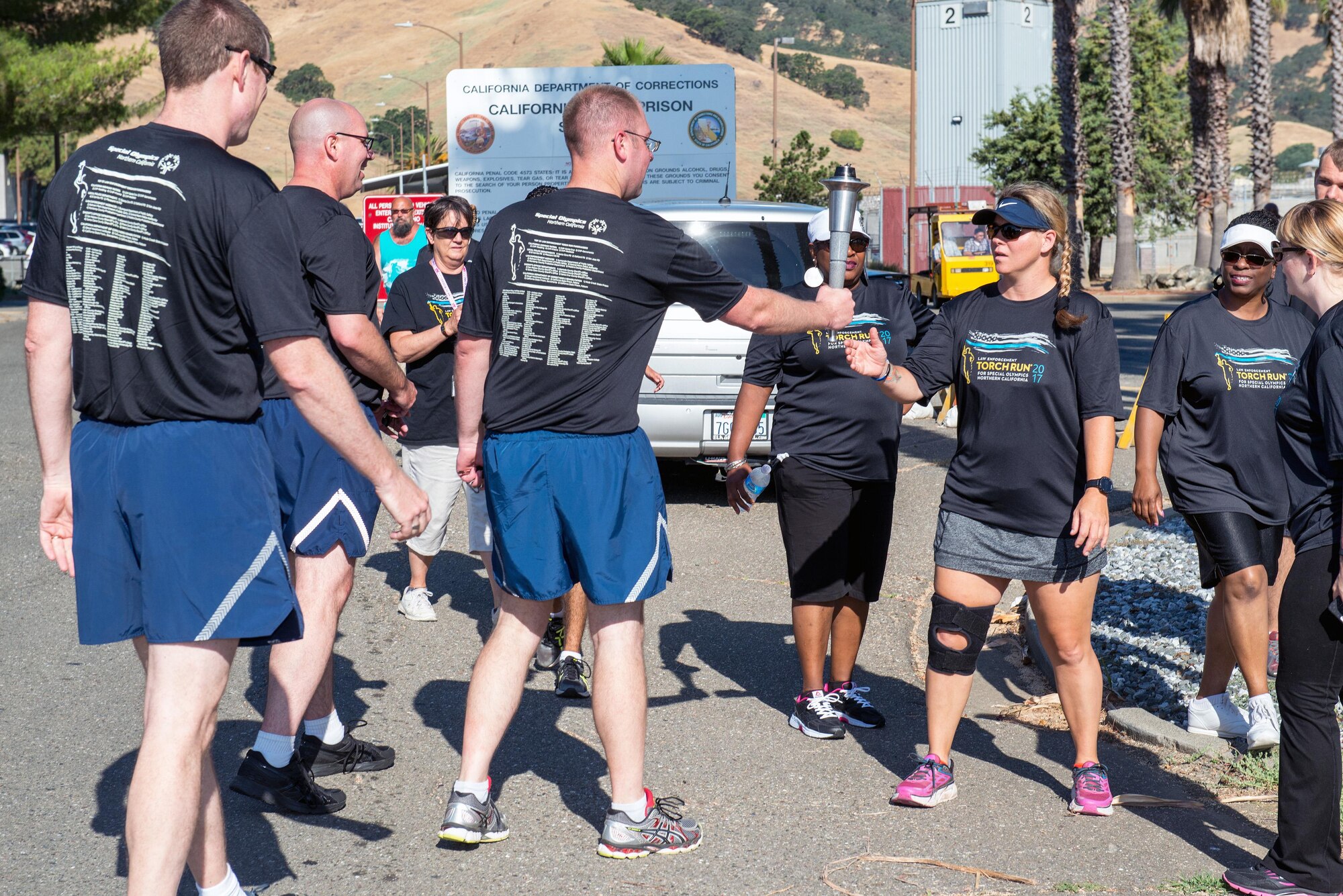 Members of the 60th Security Forces Squadron deliver “The Flame of Hope” Special Olympics Torch to the California Department of Corrections prison facility in Vacaville, Calif., June 22, 2017. The defenders joined local law enforcement from Solano County to show their support for the Special Olympics. (U.S. Air Force photo by Louis Briscese)