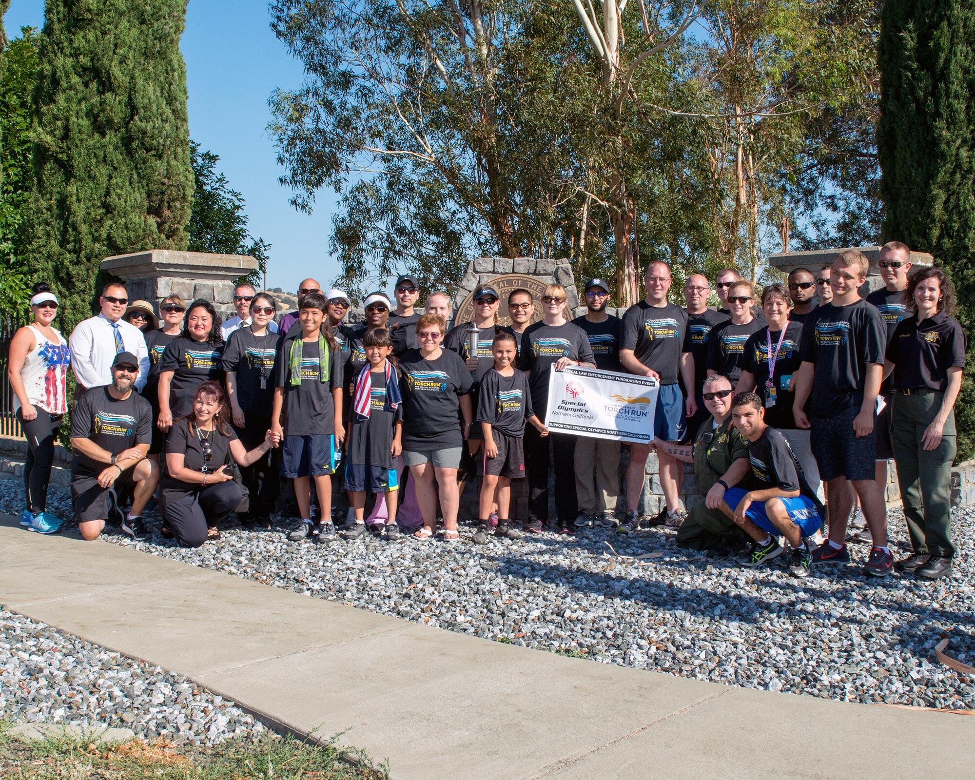 Members of the 60th Security Forces Squadron, California Department of Corrections prison facility in Solano County, and Special Olympics athletes pose for a photo in Vacaville, Calif., June 22, 2017. The defenders ran “The Flame of Hope” Special Olympics Torch from Travis Air Force Base, Calif., to the prison. The event brings local law enforcement together from Solano County to show their support for the Special Olympics. (U.S. Air Force photo by Louis Briscese)