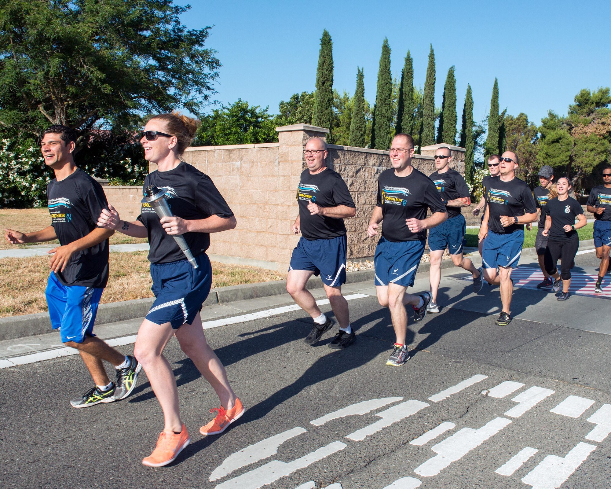 Members of the 60th Security Forces Squadron run with “The Flame of Hope” Special Olympics Torch at Travis Air Force Base, Calif., June 22, 2017. The defenders are running the torch to the California Department of Corrections prison facility in Vacaville, Calif. The event brings local law enforcement together from Solano County to show their support for the Special Olympics. (U.S. Air Force photo by Louis Briscese)