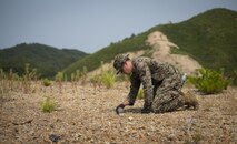 Sgt. Andrew E. Mattson, an explosive ordnance disposal technician, examines unexploded ordnance at Suseongri Live Fire Range near Pohang, Republic of Korea, June 17, 2017, in preparation of Korean Marine Exchange Program 17-7. EOD swept the range to clear it of any UXO allowing the ROK and U.S. Marines to conduct training in a safer environment. KMEP 17-7 is just one of the many opportunities for ROK and U.S. Marines to learn from one another. Boatwright is from Superior, Wisconsin and is attached to 3rd EOD Company, 9th Engineer Support Battalion, 3rd Marine Logistics Group, III Marine Expeditionary Force. (U.S. Marine Corps photo by Lance Cpl. Andy Martinez)