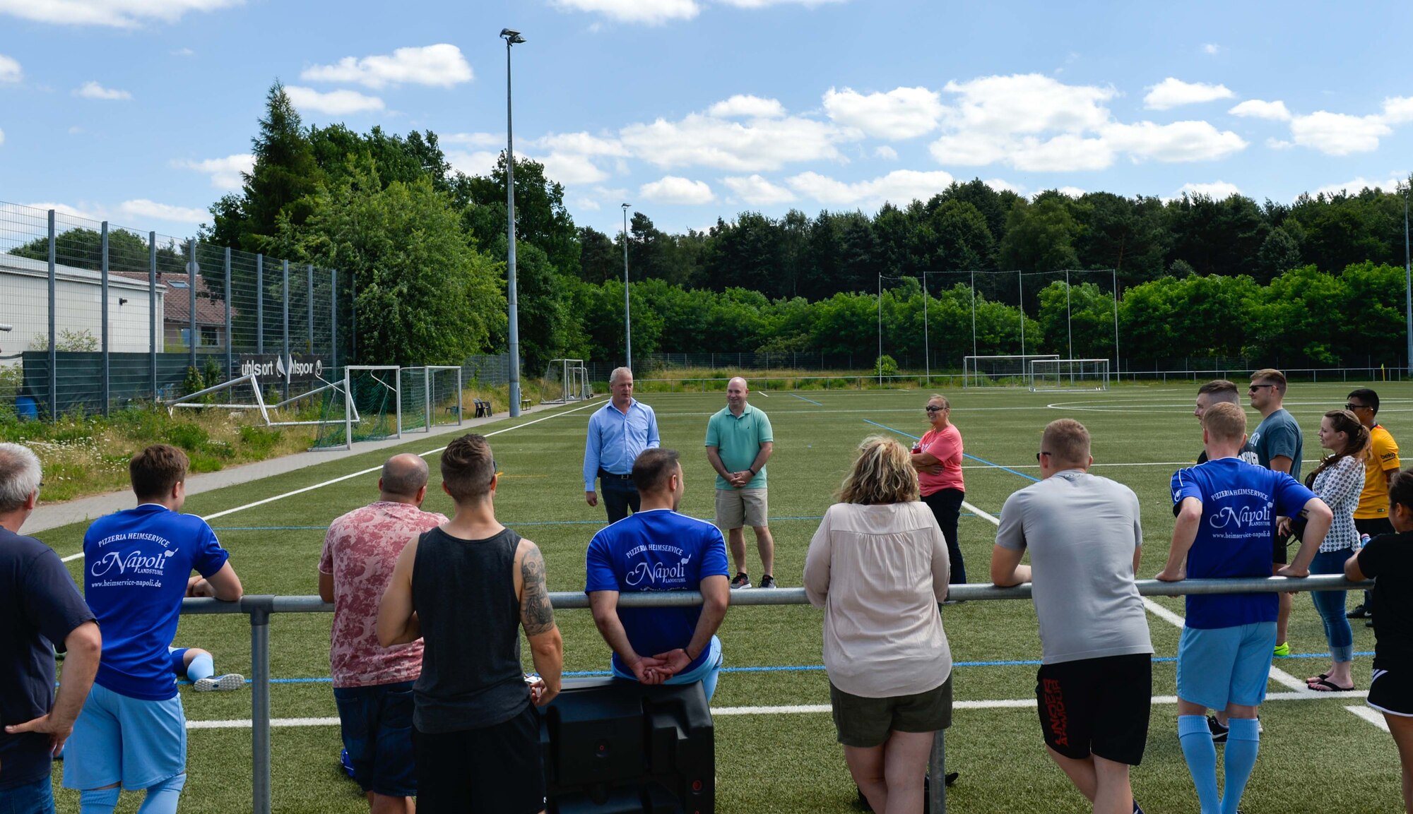 Ralf Hechler, Ramstein-Miesenbach mayor of the Union Community, left, and U.S. Air Force Chief Master Sgt. Aaron D. Bennett, 86th Airlift Wing command chief, welcome Ramstein Air Base Airmen and Fussballverein Ramstein Fußball Club A-Team to the Grassroots program sports day, at FV Olympia Field in Ramstein Misenbach, Germany, June 24, 2017. Grassroots is a new program initiated by the 86th AW Host Nations office, Public Affairs community engagement team and Chaplain Corps. (U.S. Air Force photo by Staff Sgt. Nesha Humes)