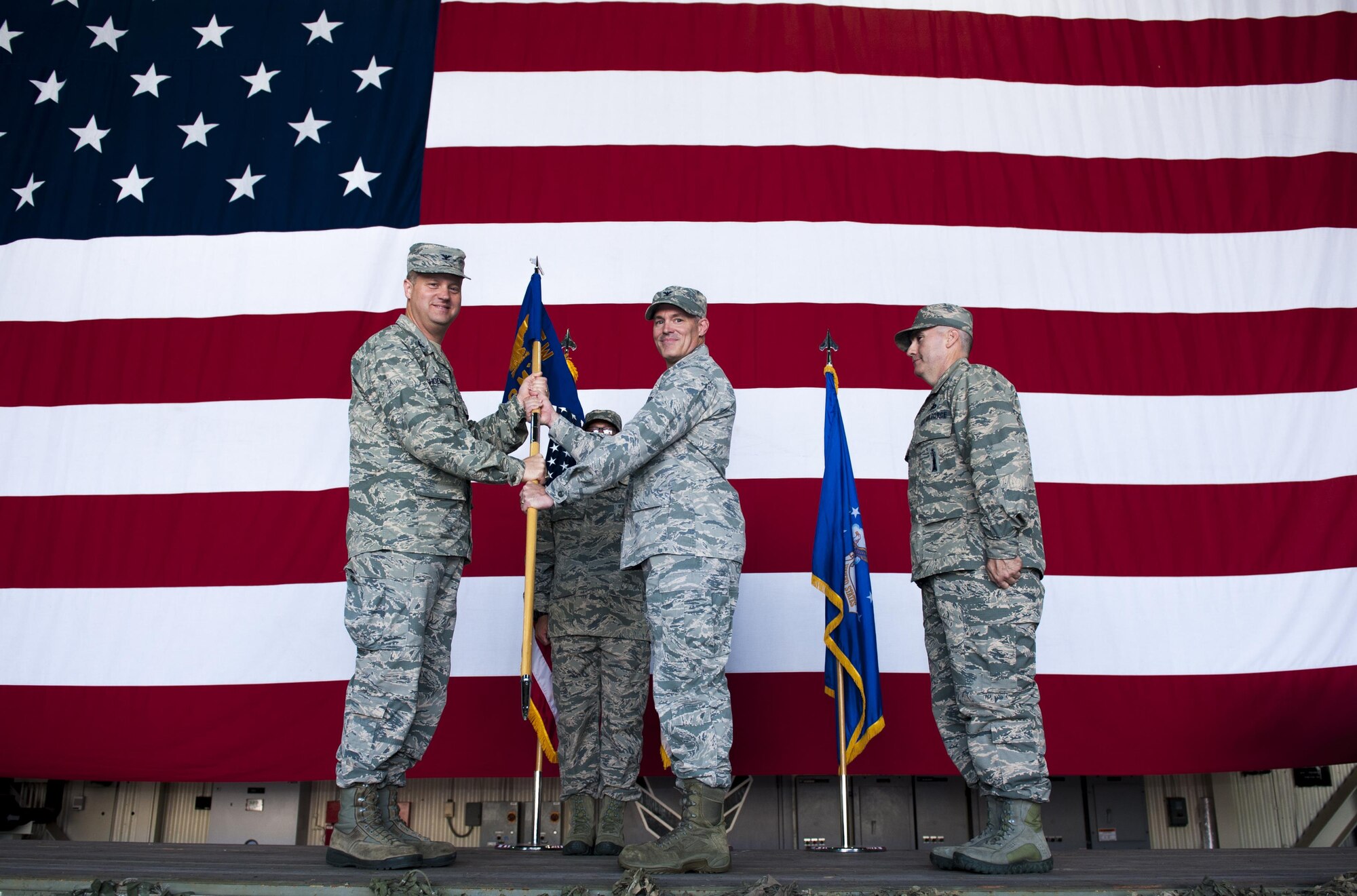 U.S. Air Force Col. George Sebren, 8th Maintenance Group commander, receives the guidon from Col. David Shoemaker, 8th Fighter Wing commander, during a change of command ceremony held June 28, 2017, at Kunsan Air Base, Republic of Korea. Shoemaker presided over the ceremony in which Col. James Long relinquished command of the 8th MXG to Sebren. (U.S. Air Force photo by Senior Airman Colville McFee/Released)
