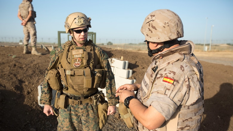 Warrant Officer Dan Pare, the explosive ordnance disposal officer for Special Purpose Marine Air-Ground Task Force-Crisis Response-Africa, speaks with Sub-officer Major Benito Florido Cauovas, the EOD sub-officer major for the Spanish Second Air Support Deployment Squadron (SEADA), during preparation for a live-fire explosive training at Morón Air Base, Spain, June 20, 2017. This was the first time, either jointly or separately, U.S. and Spanish EOD personnel conducted live, explosive ordnance training on the air base. (U. S. Marine Corps photo by Staff Sgt. Kenneth K. Trotter Jr./Released)