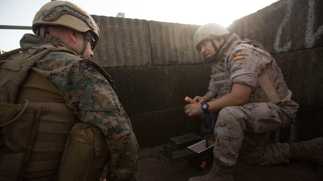 Warrant Officer Dan Pare, left, the explosive ordnance disposal officer for Special Purpose Marine Air-Ground Task Force-Crisis Response-Africa, speaks with Sub-officer Major Benito Florido Cauovas, the EOD sub-officer major for the Spanish Second Air Support Deployment Squadron (SEADA), who talks about some of the qualities of Spanish dynamite and what can be expected from it during a joint EOD live-fire demolition training at Morón Air Base, Spain, June 20, 2017. This was the first time, either jointly or separately, U.S. and Spanish EOD personnel conducted live, explosive ordnance training on the air base. (U. S. Marine Corps photo by Staff Sgt. Kenneth K. Trotter Jr./Released)