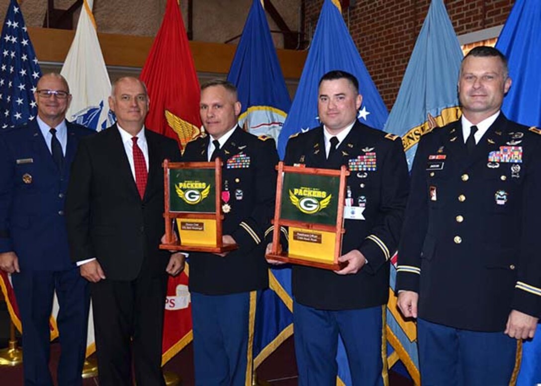 Army Col. Mark Hirschinger, center left, and Army Chief Warrant Officer 4 Kevin Ryan receive farewell gifts from their teammates in the Army Customer Facing Division, Defense Logistics Agency Aviation on the occasion of their retirement in a joint ceremony held June 22, 2017 on Defense Supply Center Richmond, Virginia. Also pictured from left:  DLA Aviation Commander Air Force Brig. Gen. Allan Day, Deputy Chief Army Customer Facing Division Craig Hughes and Chief Warrant Officer 3 Michael Jackson, right, aviation maintenance technician, Army Customer Facing Division.