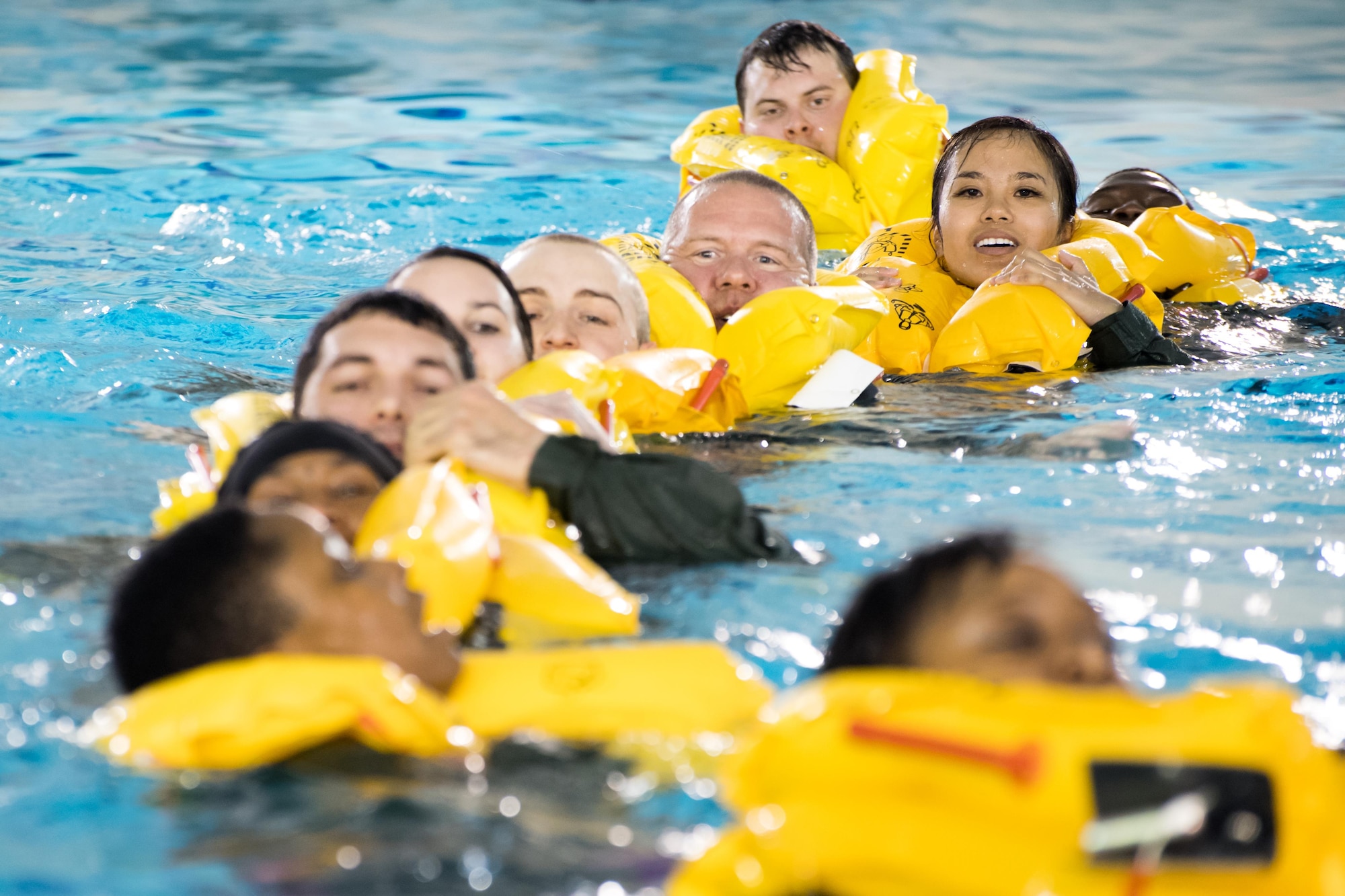 POPE ARMY AIRFIELD, N.C. -- Aircrew members from the 43d Aeromedical Evacuation Squadron and 43d Operations Support Squadron here swim together towards a life raft during a Survival, Evasion, Rescue and Escape water survival course May 16. Aircrew members complete the course to maintain proficiency in the use of flotation devices and other available equipment during an overwater emergency. SERE specialists from the 437th OSS at Joint Base Charleston, S.C., provided the training for Airmen at Pope Field. (U.S. Air Force photo/Marc Barnes)