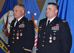 Army Col. Mark Hirschinger, left, and Army Chief Warrant Officer 4 Kevin Ryan stand at attention during the reading of their retirement orders at the joint ceremony held June 22, 2017 on Defense Supply Richmond, Virginia.  Hirschinger and Ryan devoted 30 and 22 years, respectively, of dedicated service to their country