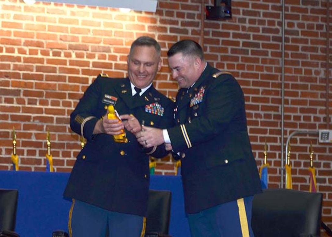 Army Col. Mark Hirschinger, left, and Army Chief Warrant Officer 4 Kevin Ryan share a laugh over a shampoo bottle guaranteeing ‘no more tears’ prior to their joint retirement ceremony held June 22, 2017 on Defense Supply Center Richmond, Virginia.  Hirschinger and Ryan have served a combined 52 years of service, closing out their careers in the Customer Operations Directorate of Defense Logistics Agency Aviation.