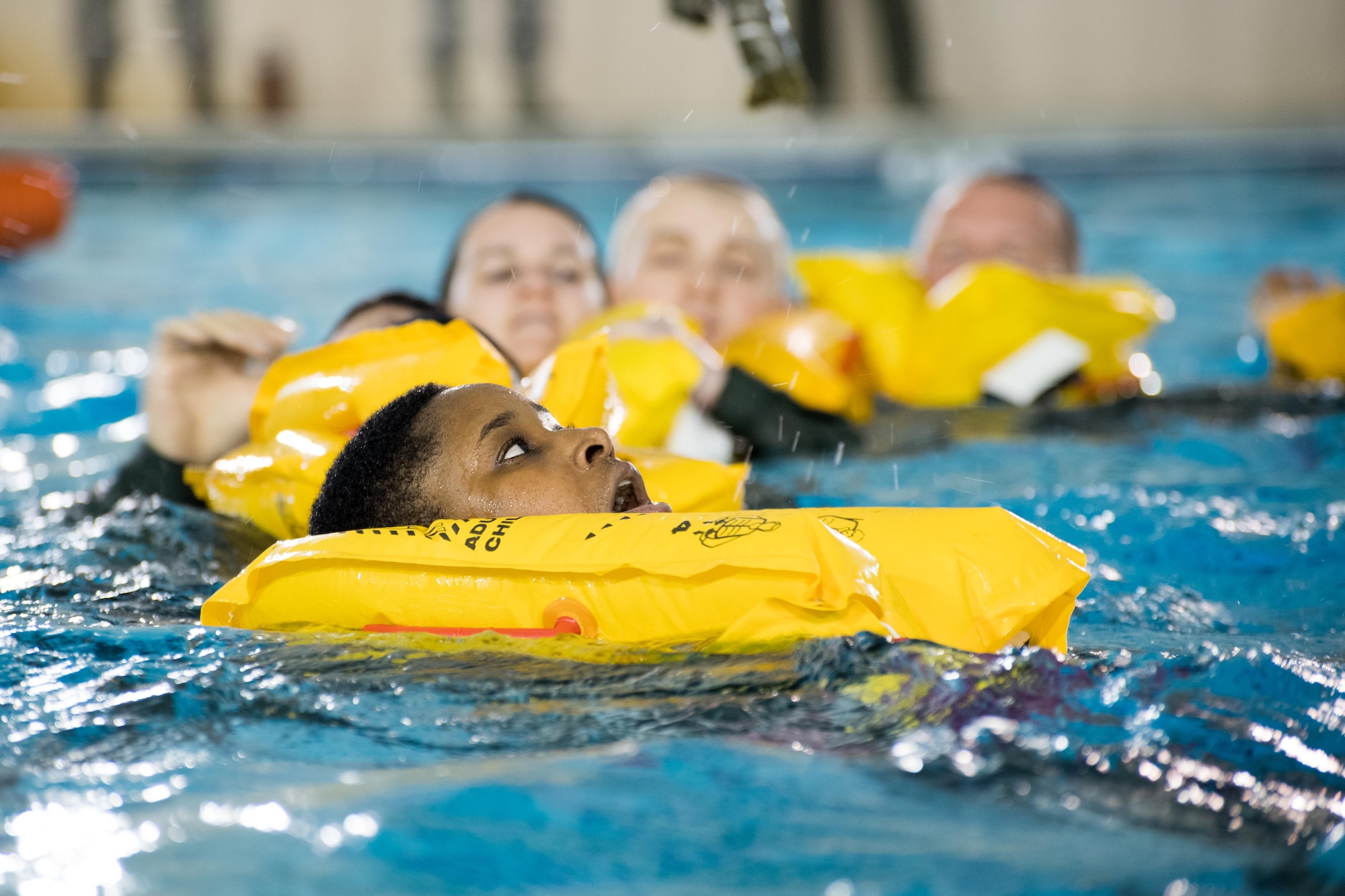 POPE ARMY AIRFIELD, N.C. -- Staff Sgt. Jaquel Freeny, an aeromedical evacuation technician in the 43d Aeromedical Evacuation Squadron, swims toward a life raft along with fellow aircrew members here during a SERE water survival course May 16. Aircrew members in the 43d AES and 43d Operations Support Squadron completed the course to maintain proficiency in the use of flotation devices and other available equipment during an overwater emergency. The 43d AES and 43d OSS are part of the 43d Air Mobility Operations Group here at Pope Field. (U.S. Air Force photo/Marc Barnes)