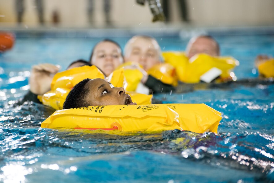POPE ARMY AIRFIELD, N.C. -- Staff Sgt. Jaquel Freeny, an aeromedical evacuation technician in the 43d Aeromedical Evacuation Squadron, swims toward a life raft along with fellow aircrew members here during a SERE water survival course May 16. Aircrew members in the 43d AES and 43d Operations Support Squadron completed the course to maintain proficiency in the use of flotation devices and other available equipment during an overwater emergency. The 43d AES and 43d OSS are part of the 43d Air Mobility Operations Group here at Pope Field. (U.S. Air Force photo/Marc Barnes)
