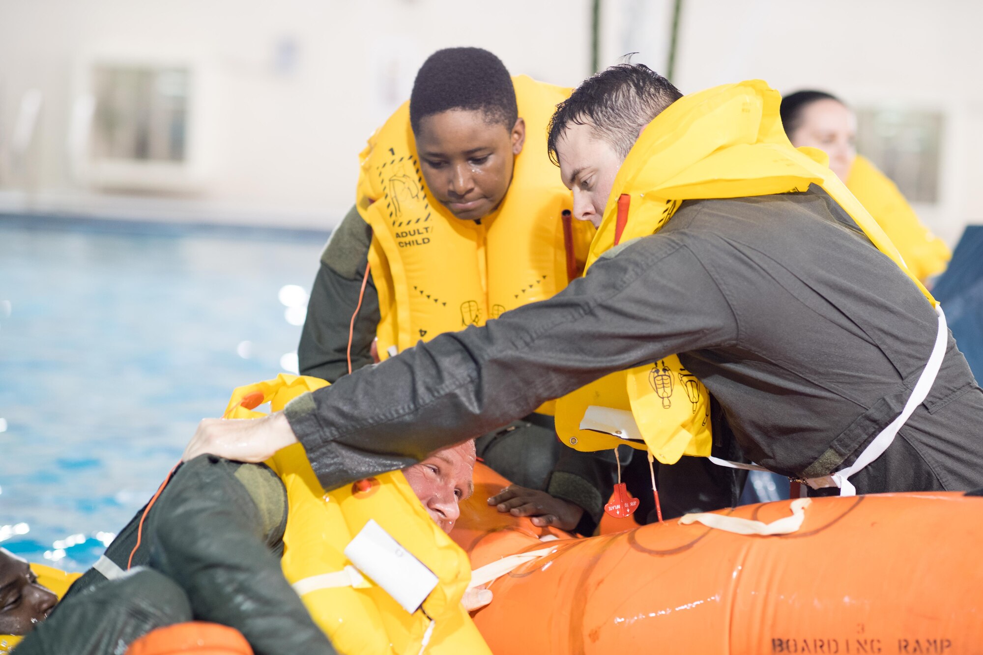 POPE ARMY AIRFIELD, N.C. -- Members of the 43d Aeromedical Evacuation Squadron here work together to board a life raft during a Survival, Evasion, Rescue and Escape water survival course May 16, 2017. The training allows aircew members to maintain profiency proficiency in the use of flotation devices and other available equipment during an overwater emergency. SERE specialists from the 437th Operations Support Squadron at Joint Base Charleston provided the training for Airmen at Pope Field.  (U.S. Air Force photo/Marc Barnes)