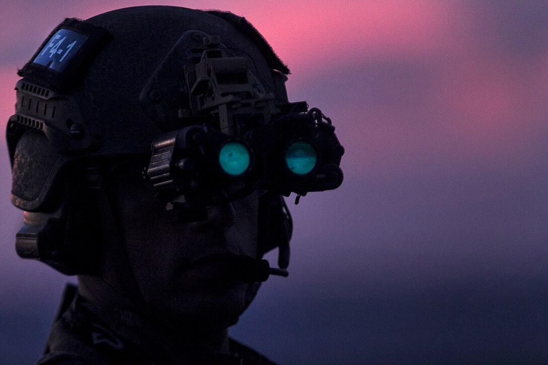 A Marine wearing night vision goggles waits on the flight deck before participating fast-rope training during low light aboard the USS Bonhomme Richard in the Pacific Ocean, June 25, 2017. Marine Corps photo by Staff Sgt. T. T. Parish