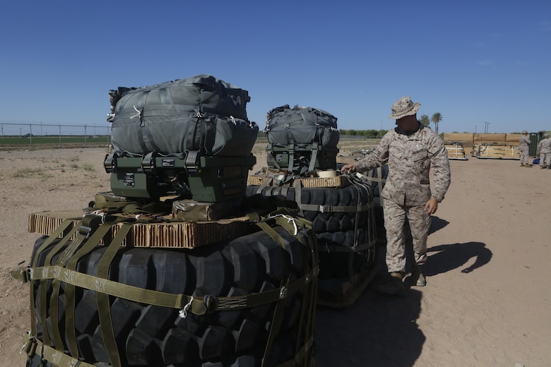 U.S Marine Pfc. Brad A. Clark inspects the rigged aerial delivery systems of Joint Precision Airdrop Systems during a Weapons and Training Instructor Course March 30, 2017, at Marine Corps Air Station Yuma, Ariz. The JPADS systems use GPS, a modular autonomous guidance unit, or MAGU, a parachute and electric motors to guide cargo within 150 meters of their target points. Marine Corps Systems Command fielded the last of 162 JPADS to the fleet in April, turning the page from acquisition to sustainment of the system for the Corps. (U.S. Marine Corps photo by Lance Cpl. Jocelyn Ontiveros)