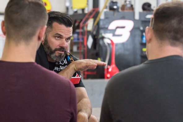 WELCOME, N.C. -- Ray Wright, a pit crew coach with Richard Childress Racing here, talks with Airmen from the 43d Aeromedical Squadron during a teambuilding event at RCR June 13. With a big win in the Coca-Cola 600 still fresh in their memory, RCR pit crew coaches and team members trained Airmen at various pit crew positions, and then gave them the opportunity to put their training to the test in a race-style pit area during the event. (U.S. Air Force photo/Marc Barnes)