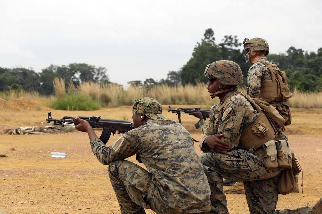 Marine Corps Lance Cpl. Tyree Lane, a security cooperation team instructor assigned to Special Purpose Marine Air-Ground Task Force Crisis Response-Africa, observes a member of the Gabonese armed forces fire an AK-47 rifle during a counter illicit trafficking course at Camp Mokekou, Gabon, June 12, 2017. Marine Corps photo by 1st Lt. Johnny Henderson