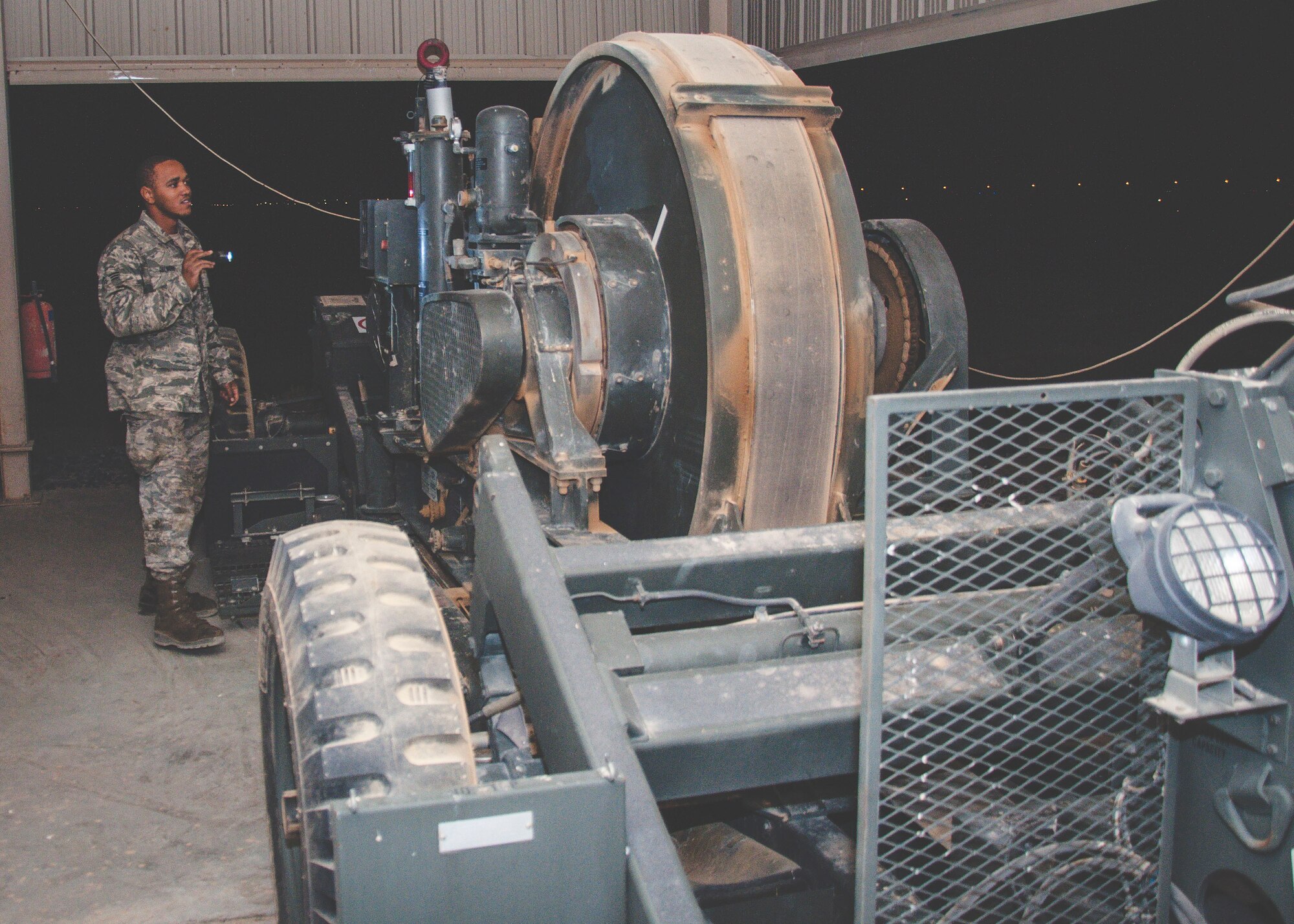 Senior Airman Quentin Palmore, a power production specialist assigned to the 386th Expeditionary Civil Engineer Squadron, conducts and inspection on a mobile aircraft arresting system at an undisclosed location in southwest Asia, June 24, 2017. A visual inspection is performed on these units daily. (U.S. Air Force Photo/Master Sgt. Eric M. Sharman)
