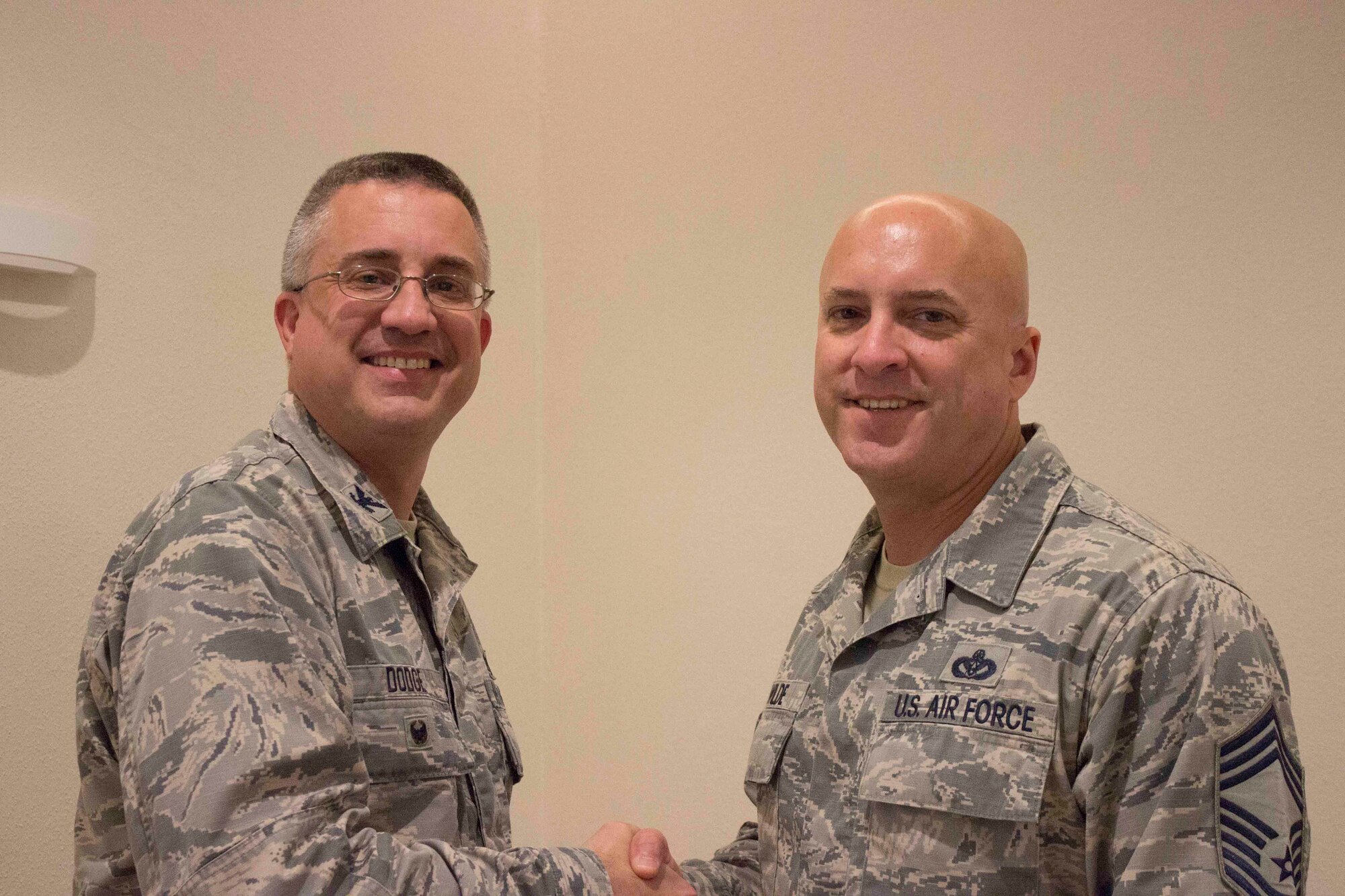 Col. Timothy Dodge, director of AFCEC's Operations Directorate, and Chief John Wilde, civil engineer chief of enlisted matters, pose for the camera during the recent Education Training and Review Committee meeting at Ramstein Air Base, Germany. Wilde coined the colonel for his advocacy and outstanding support of enlisted Airmen worldwide over the past three years. (U.S. Air Force photo/Susan Lawson)
