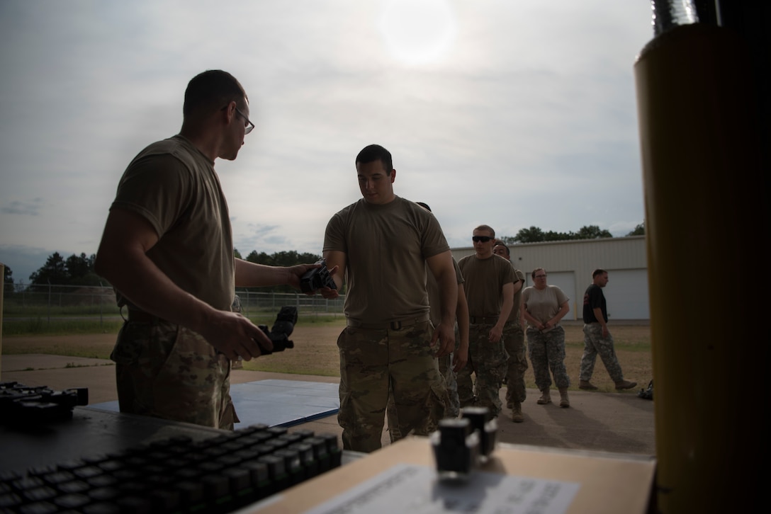 Staff Sgt. Michael L. Dye, a U.S. Army Reserve military police and interservice, non-leathal weapons instructor, issues Tasers to military police for a Taser certification class during Guardian Justice at Fort McCoy, Wisconsin, June 22. Guardian Justice is a functional exercise, broken down into two-week cycles, centered on squad and team-level training with a focus on internment, resettlement, detainee operations and combat support. During each two-week cycle, Soldiers train on internment operations, weapons qualification, biometrics, reflexive fire, Military Operations on Urbanized Terrain (MOUT), non-lethal Tasers, MP battle drills and situational training exercises. (U.S. Army Reserve photo by Sgt. Audrey Hayes)