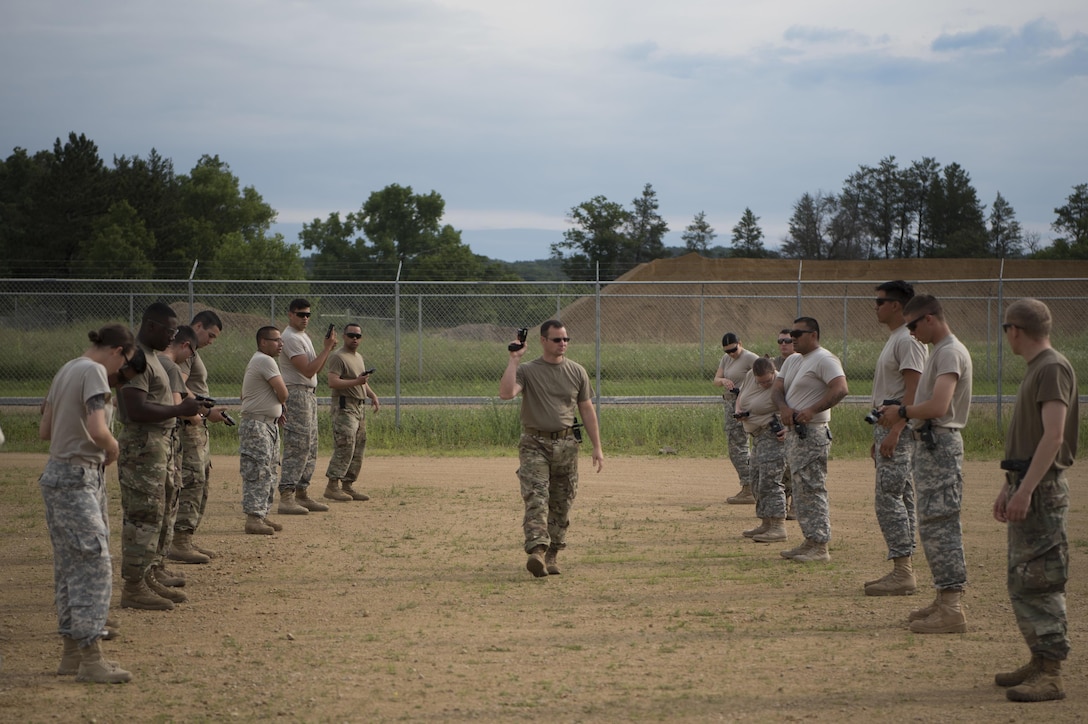 U.S. Army Reserve military police from the 324th MP Battalion, located in Fresno, California and the 422nd MP Company in Bakersfield, California familiarize themselves with drawing and holstering a Taser during Guardian Justice at Fort McCoy, Wisconsin, June 22. Guardian Justice is a functional exercise, broken down into two-week cycles, centered on squad and team-level training with a focus on internment, resettlement, detainee operations and combat support. During each two-week cycle, Soldiers train on internment operations, weapons qualification, biometrics, reflexive fire, Military Operations on Urbanized Terrain (MOUT), non-lethal Tasers, MP battle drills and situational training exercises. (U.S. Army Reserve photo by Sgt. Audrey Hayes)
