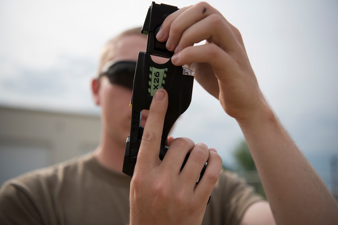 A U.S. Army Reserve military police with the 422 MP Company, located in Bakersfield, California, loads a live Taser cartridge during Guardian Justice at Fort McCoy, Wisconsin, June 22. Guardian Justice is a functional exercise, broken down into two-week cycles, centered on squad and team-level training with a focus on internment, resettlement, detainee operations and combat support. During each two-week cycle, Soldiers train on internment operations, weapons qualification, biometrics, reflexive fire, Military Operations on Urbanized Terrain (MOUT), non-lethal Tasers, MP battle drills and situational training exercises. (U.S. Army Reserve photo by Sgt. Audrey Hayes)
