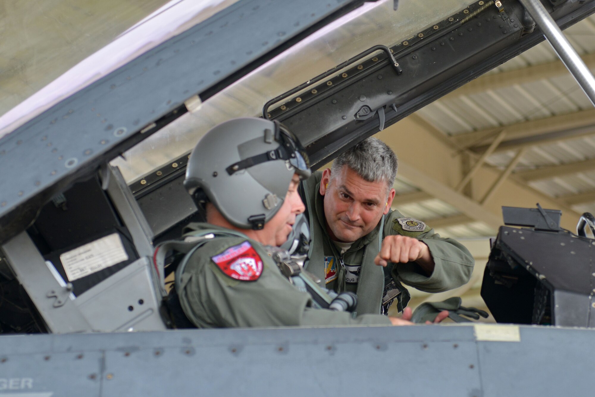 U.S. Air Force Col. Douglas Thies, 20th Operations Group commander, prepares to fist bump Col. David Vaclavik, 20th Mission Support Group commander, prior to a familiarization flight at Shaw Air Force Base, S.C., May 30, 2017. Thies flew Vaclavik, who has been his friend since college, on a familiarization flight training mission in an F-16D Fighting Falcon. (U.S. Air Force photo by Airman 1st Class Destinee Sweeney)