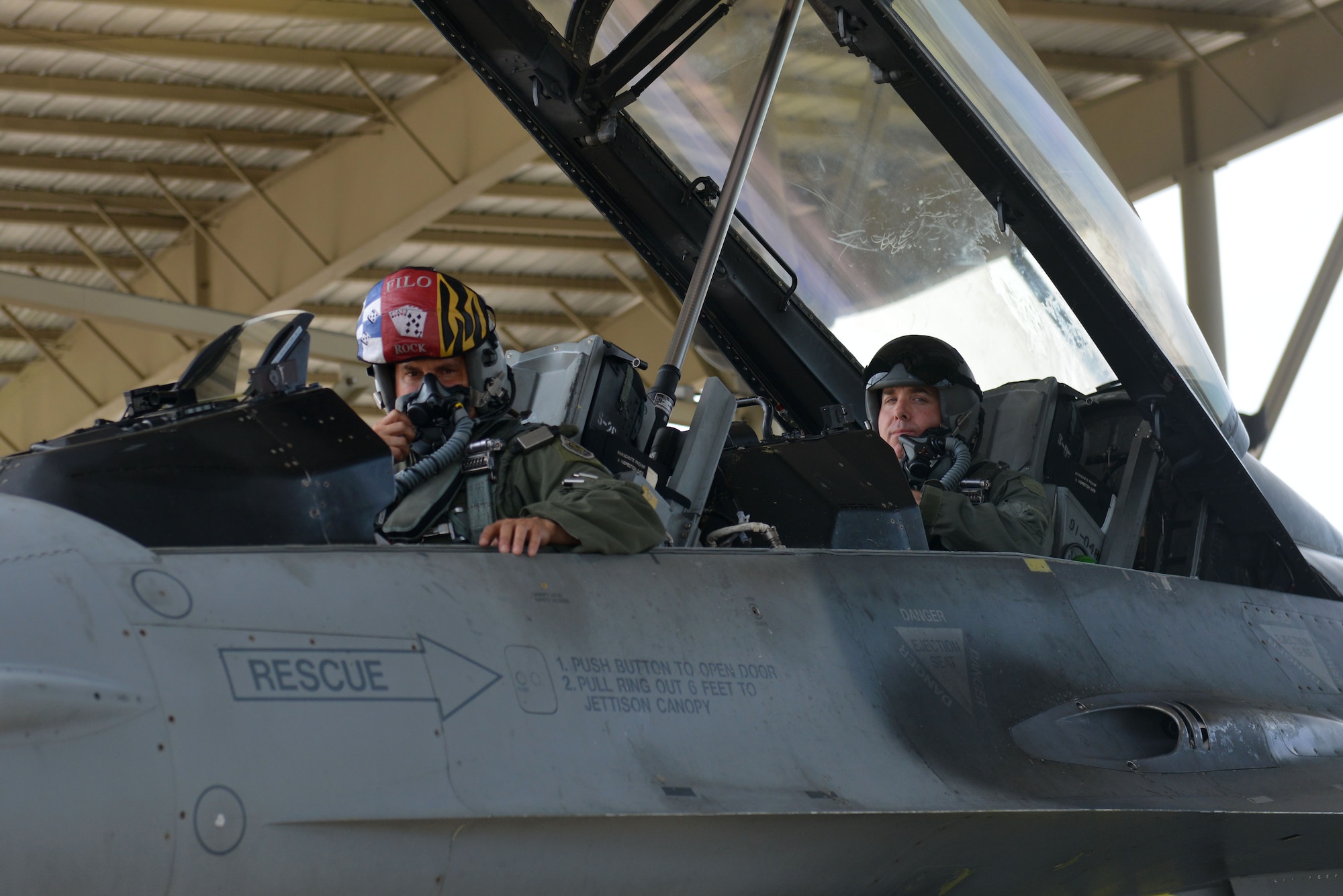 U.S. Air Force Col. Douglas Thies, 20th Operations Group (OG) commander, and Col. David Vaclavik, 20th Mission Support Group commander, wait for their tactical aircraft maintainer to finish an inspection prior to takeoff at Shaw Air Force Base, S.C., May 30, 2017. The two friends had a familiarization flight together prior to Thies passing on the guidon during the 20th OG change of command scheduled for June 30, 2017. (U.S. Air Force photo by Airman 1st Class Destinee Sweeney)