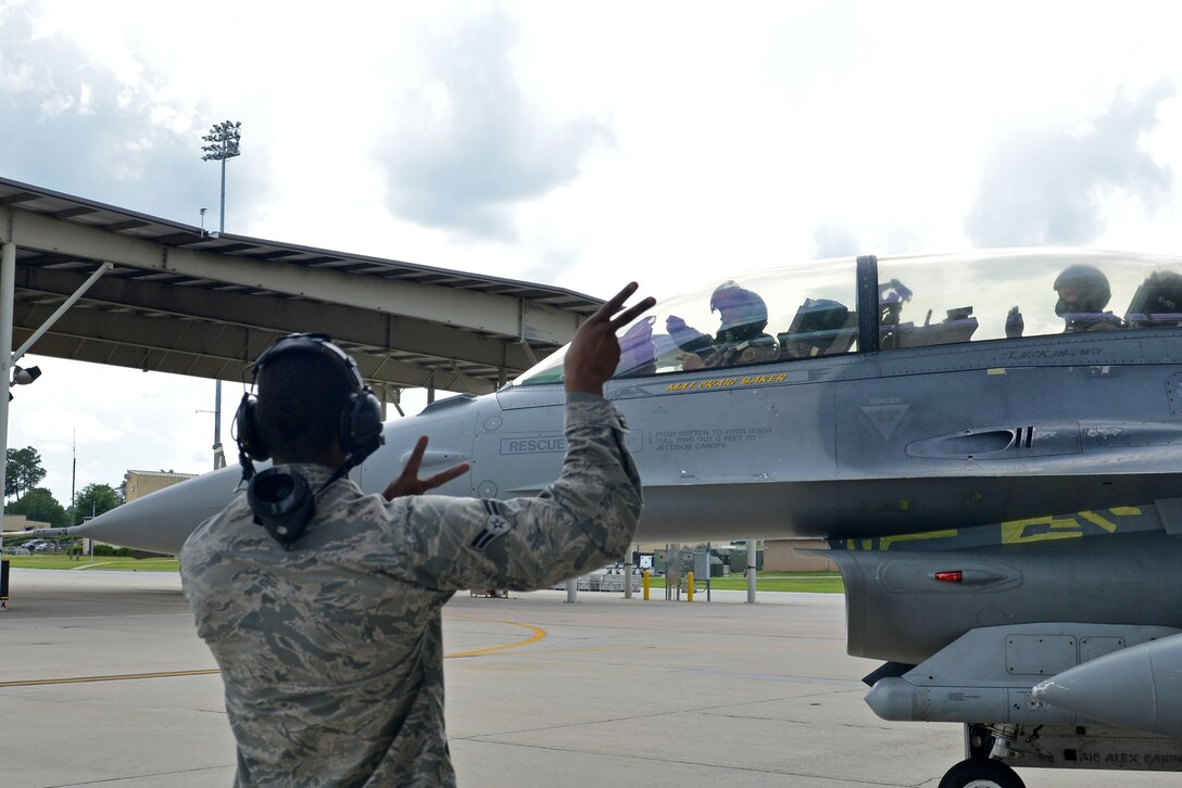 A U.S. Airman marshals out Col. Douglas Thies, 20th Operations Group commander, and Col. David Vaclavik, 20th Mission Support Group commander, in an F-16D Fighting Falcon at Shaw Air Force Base, S.C., May 30, 2017. Shaw marked the first assignment Thies and Vaclavik have had together since they graduated from the Texas A&M University Cadet Corps. (U.S. Air Force photo by Airman 1st Class Destinee Sweeney)