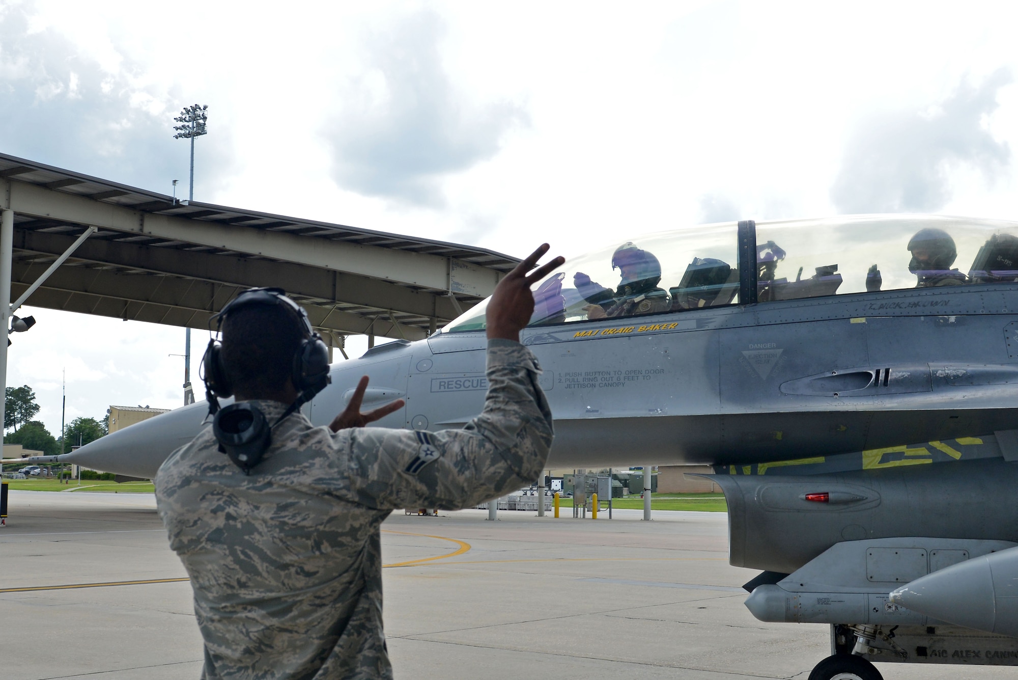 A U.S. Airman marshals out Col. Douglas Thies, 20th Operations Group commander, and Col. David Vaclavik, 20th Mission Support Group commander, in an F-16D Fighting Falcon at Shaw Air Force Base, S.C., May 30, 2017. Shaw marked the first assignment Thies and Vaclavik have had together since they graduated from the Texas A&M University Cadet Corps. (U.S. Air Force photo by Airman 1st Class Destinee Sweeney)