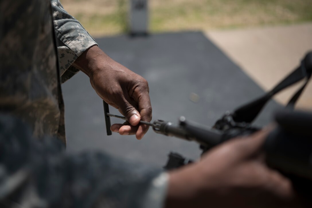 A U.S. Army Reserve military police with the 354th MP Company from St. Louis, Missouri, inspects the barrel of an M4 with a rod before allowing soldiers to enter a range for reflexive fire training during Guardian Justice at Fort McCoy, Wisconsin, June 23. Guardian Justice is a functional exercise, broken down into two-week cycles, centered on squad and team-level training with a focus on internment, resettlement, detainee operations and combat support. During each two-week cycle, Soldiers train on internment operations, weapons qualification, biometrics, reflexive fire, Military Operations on Urbanized Terrain (MOUT), non-lethal Tasers, MP battle drills and situational training exercises. (U.S. Army Reserve photo by Sgt. Audrey Hayes)