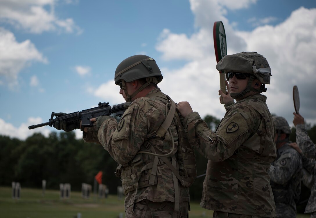 U.S. Army Reserve military police with the 354th MP Company from St. Louis, Missouri participate in reflexive fire training during Guardian Justice at Fort McCoy, Wisconsin, June 23. Guardian Justice is a functional exercise, broken down into two-week cycles, centered on squad and team-level training with a focus on internment, resettlement, detainee operations and combat support. During each two-week cycle, Soldiers train on internment operations, weapons qualification, biometrics, reflexive fire, Military Operations on Urbanized Terrain (MOUT), non-lethal Tasers, MP battle drills and situational training exercises. (U.S. Army Reserve photo by Sgt. Audrey Hayes)