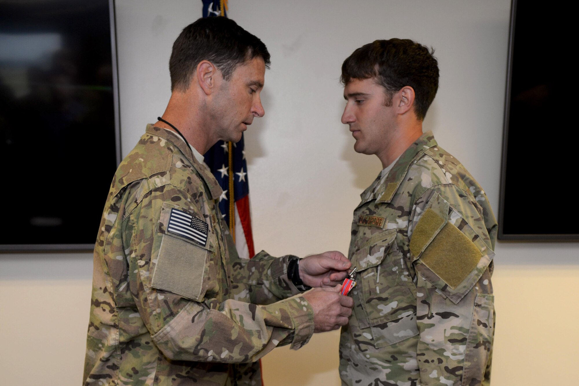 U.S. Air Force Col. Matthew Smith, left, 352d Special Operations Wing commander, pins the Bronze Star Medal on U.S. Air Force Staff Sgt. Joshua Kirby, right, 321st Special Tactic Squadron, June 27, 2017, on RAF Mildenhall, England. While deployed, Kirby exhibited meritorious service during combat operations, thus earning the Bronze Star Medal. (U.S. Air Force photo by Airman 1st Class Tenley Long)