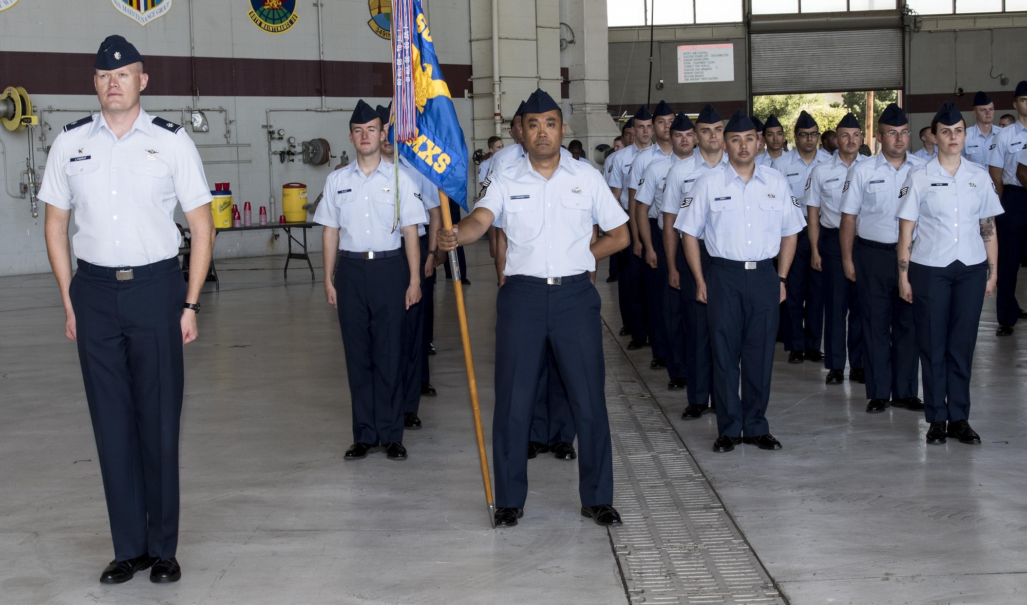 Lt. Col. Jens Lyndrup, 660th Aircraft Maintenance Squadron commander, stands at attention with his squadron during the 60th Maintenance Group Change of Command Ceremony where Col. Earl S. Scott relinquished command to Col. David A. Hammerschmidt, June 23, 2017. The 60th Maintenance Group has 2,200+ active, civilian, and reserve personnel supporting organizational and field-level maintenance for 18 C-5M Super Galaxy, 13 C-17 Globemaster, and 27 KC-10 Extender aircraft. at Air Mobility Command's largest wing. U.S. Air Force Col. Earl S. Scott relinquished command to Col. David A. Hammerschmidt during a ceremony rooted in military history dating back to the 18th Century where the command flag is passed to the individual assuming command in the presence of the entire unit. (U.S. Air Force photo/ Heide Couch)