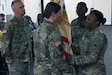 Command Sgt. Maj. Andrea Dailey (right), 408th Contracting Support Brigade senior enlisted advisor, passes the 408th CSB’s colors to Col. Michelle Sanner (left), 408th CSB outgoing commander, during a change of command ceremony at Shaw Air Force Base, S.C. Thursday. Sanner relinquished command of the 408th CSB to Col. Kim Thomas (second to left), 408th incoming CSB commander.