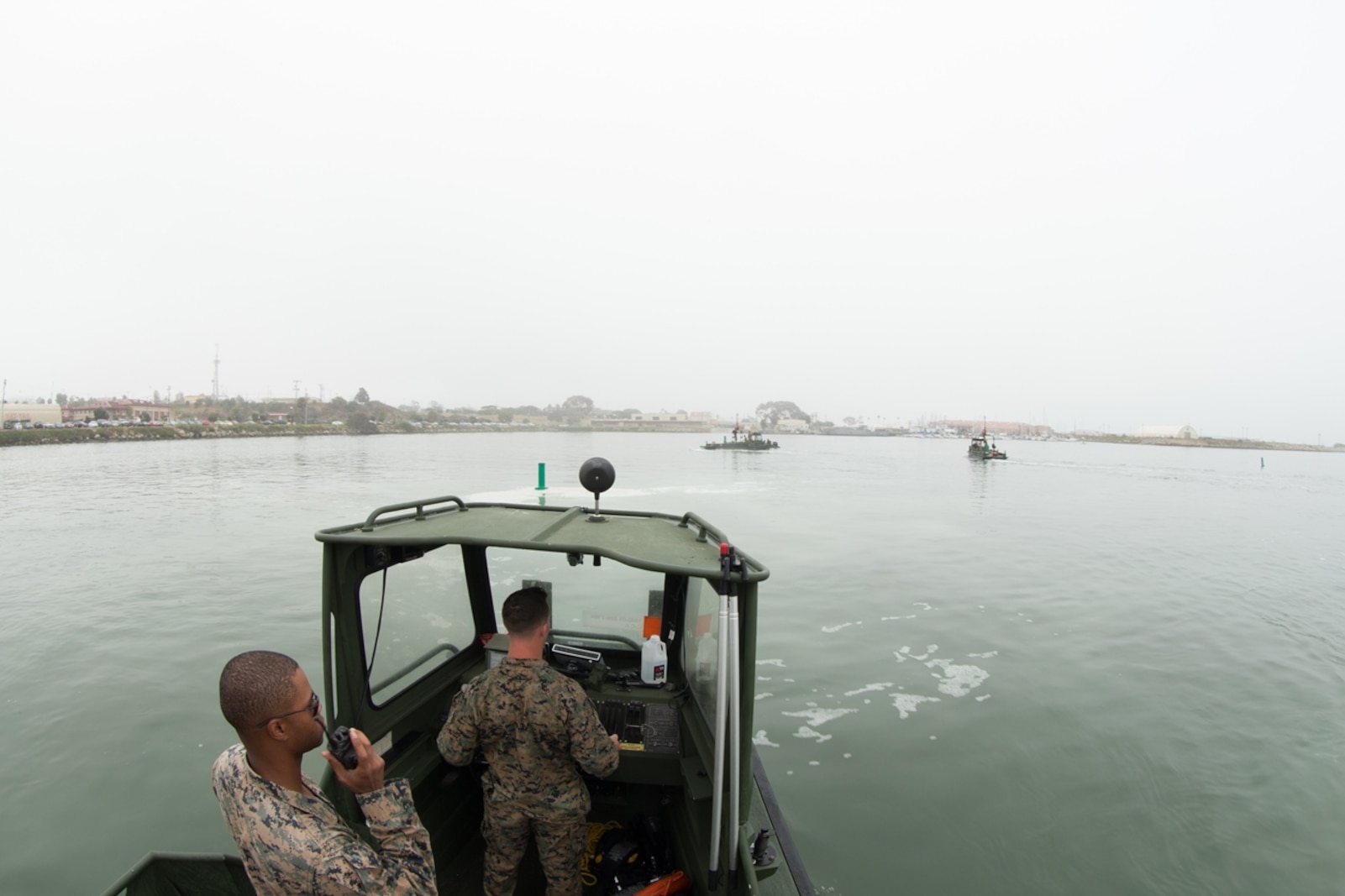 U.S. Marine Sgt. Lewis Kennedy, a combat engineer with Bridge Company, 7th Engineer Support Battalion, 1st Marine Logistics Group communicates over the radio aboard a Bridge Erection Boat (BEB) during the boat licensing course along the coast of Camp Pendleton, Calif., June 21, 2017. The BEB deploys improved ribbon bridges, which are long two-way platforms used to transport heavy equipment, such as tanks, over bodies of water. (U.S. Marine Corps photo by Lance Cpl. Timothy Shoemaker)