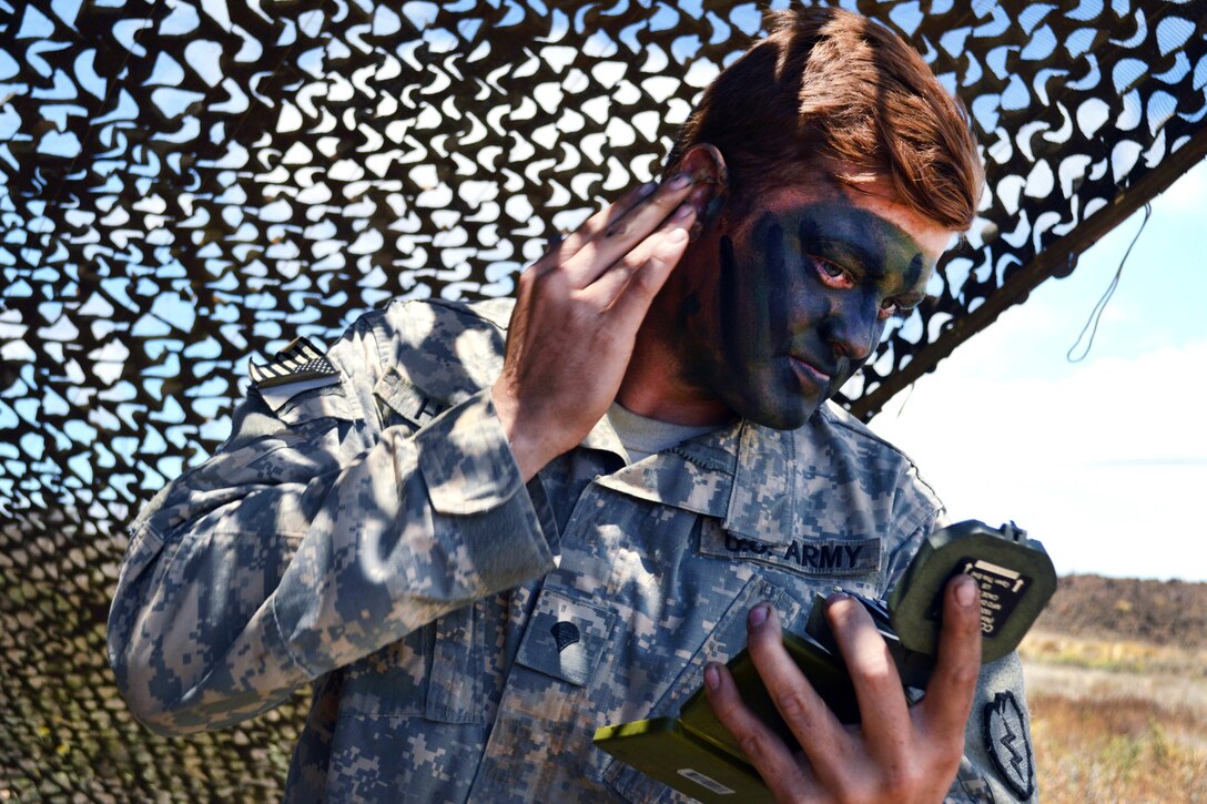 Army Spc. William Holt applies camouflage face paint at the Pohakuloa Training Area, Hawaii, June 25, 2017. Holt is an indirect fire infantryman assigned to the 25th Infantry Division’s 29th Brigade Engineer Battalion, 3rd Brigade Combat Team. Army photo by Staff Sgt. Armando R. Limon