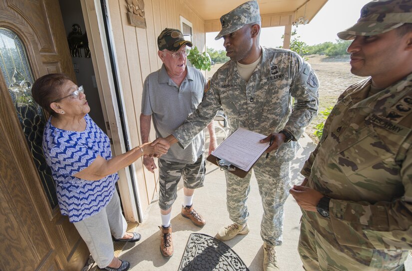 Sgt. 1st Class Rhody Merisier, middle right, and Staff Sgt. Aldo Blanco, both assigned to the 478th Civil Affairs Battalion based in Miami, conduct a survey with residents of a colonia currently without potable water near Laredo, Texas, June 23, 2017. Nearly 200 Reserve Soldiers are participating in an Innovative Readiness Training mission to improve infrastructures in colonias along the Texas-Mexico border. (Photo by Sean Kimmons)